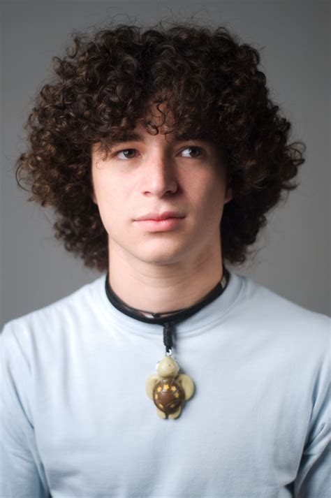 A perm is a curly or wavy style, created by rolling the hair around rods and applying heat to that. Black Men Curly Hair Perm