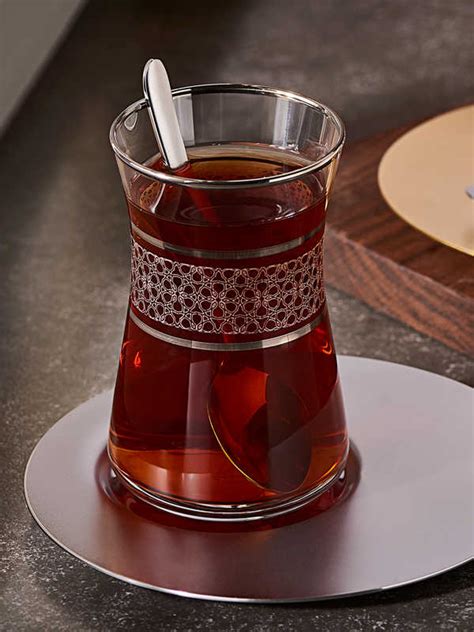 (a drink made by pouring hot water onto) dried and cut leaves and sometimes flowers, especially…. Desenli Çay Bardak