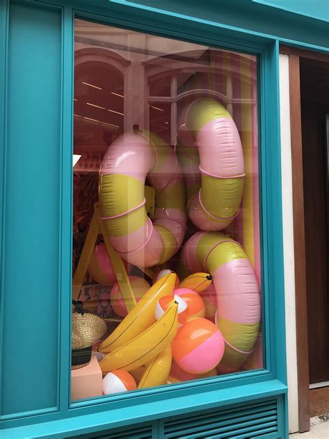There Is A Window Display With Balloons And Other Items In The Store S