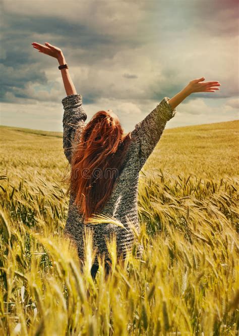 Young Red Hair Woman Standing Back Hands Up To Breathtaking View Stock