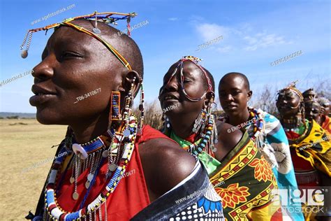 Group Of Massai Women Singing And Dancing In Traditional Dress And