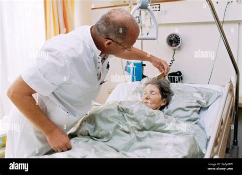 Terminal Care Hospital Nurse Combing A Terminally Ill Patients Hair Terminal Or Palliative