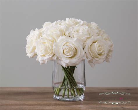 This all white lily bouquet is ideal for anniversaries or a table centerpiece. Real Touch Rose Flower Arrangement. Cream White Roses in ...