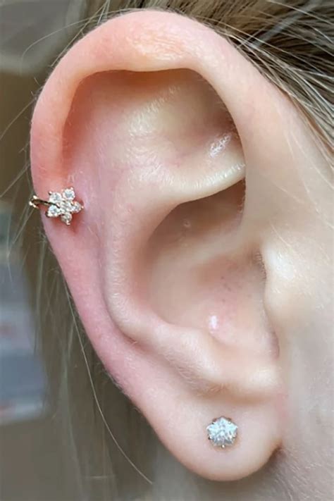 A Womans Ear With Three Small Diamond Studs