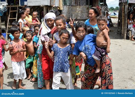 Group Of Indigenous Badjao Children Gather On Sandy Ground Happy Posing