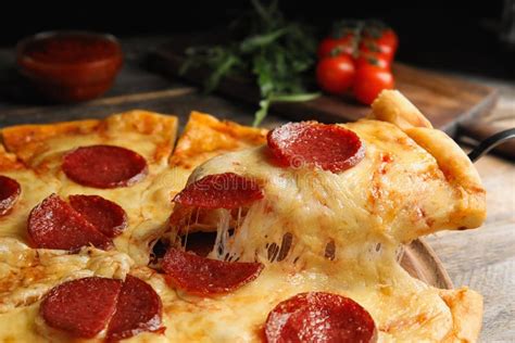 Taking Slice Of Tasty Pepperoni Pizza On Table Closeup Stock Image