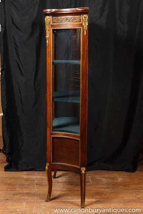 A vitrine is a glass display case or glass cabinet that is designed to display things such as figurines, artwork, china and other items one would like to protect but display. Antique French Empire Display Cabinet Vitrine 1900