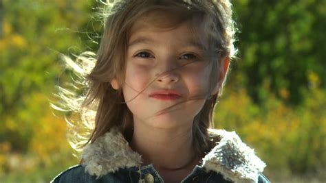 Cute Little Girl Smiles Walks Around Tree Stock Footage