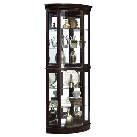 This curio cabinet features three doors, four shelves, led lighting and a wine rack. Pulaski Mirrored Corner Curio Cabinet in Sable Brown - P021577