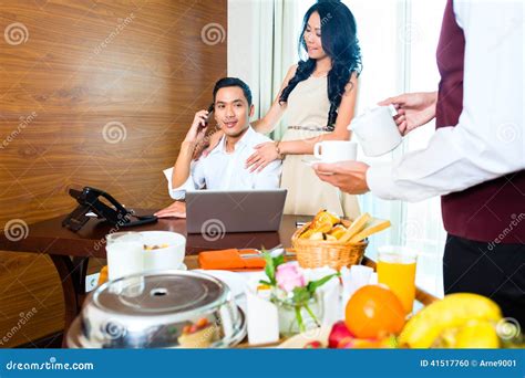 Asian Room Service Waiter Serving Breakfast In Hotel Stock Photo