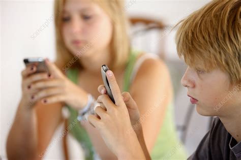 Teenagers Using Mobile Phones Stock Image C Science Photo