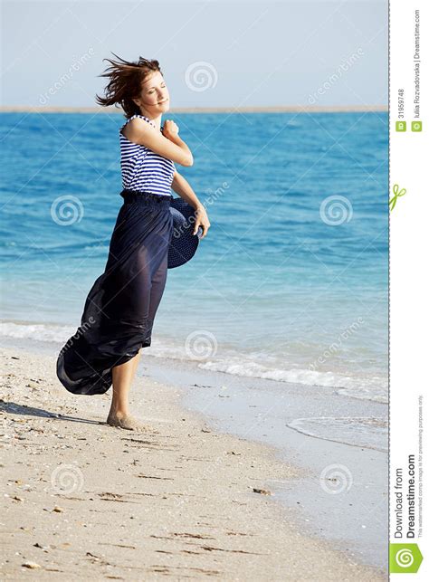 Beautiful Tanned Woman Resting On The Beach In Summer Day Stock Photo