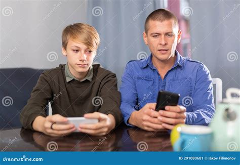 Boy With Father Resting And Playing On Phone Stock Image Image Of