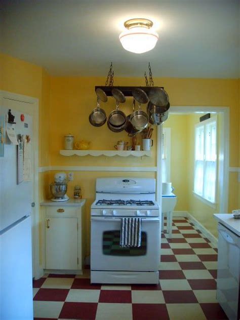 Natural woods make the highest quality kitchen cabinets by far. Yellow walls, white cabinets and appliances, with the red floor. Love it. would have made t ...