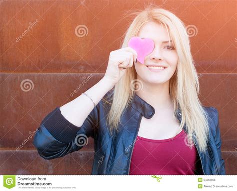 Portrait Of A Beautiful Blonde Girl With One Hand Closes