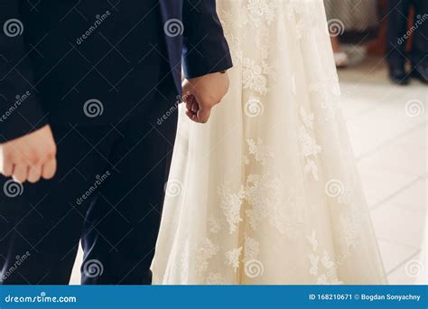 Romantic Couple Stylish Bride And Handsome Groom Holding Hands In