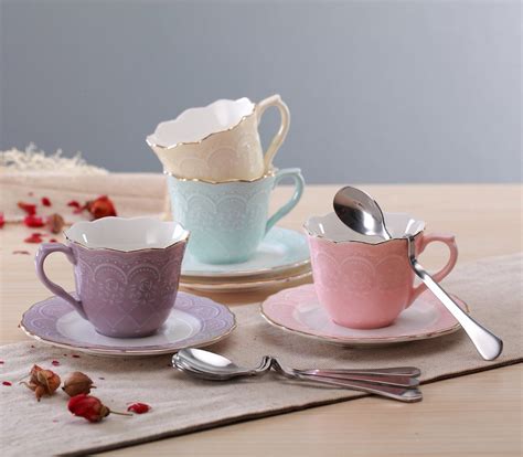 Three Cups And Saucers With Spoons On A Table
