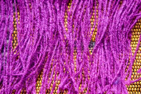 Purple Color Wool Detailed Threads Close Up On Dork Yellow Background