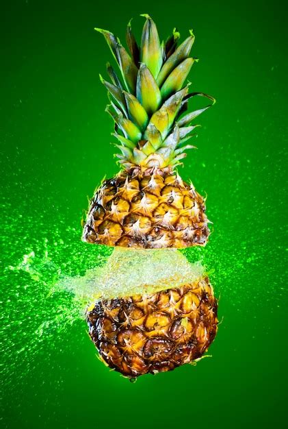 Premium Photo Pineapple Splashed With Water On A Green Wall