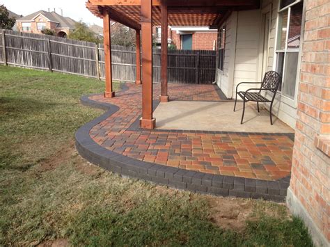 Multicolored paver patio installed around an existing concrete slab