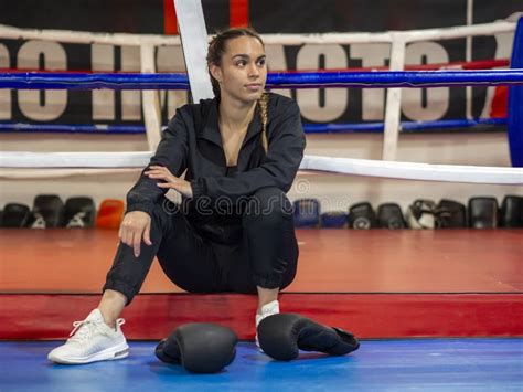 boxer girl sitting in front of boxing ring with black boxing gloves stock image image of