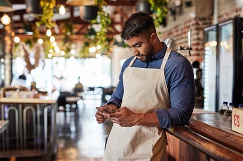 Small Business Cafe And Man Texting Or Reading Social Media And Blog