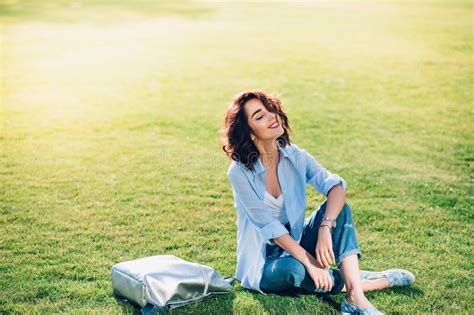 Nice Brunette Girl With Short Hair Is Chilling On Grass In Park She