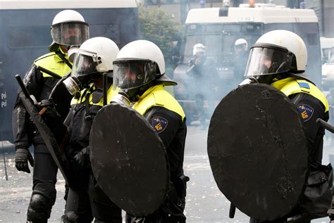 Belgian Riot Police Officers Shelter Behind Their Shields While