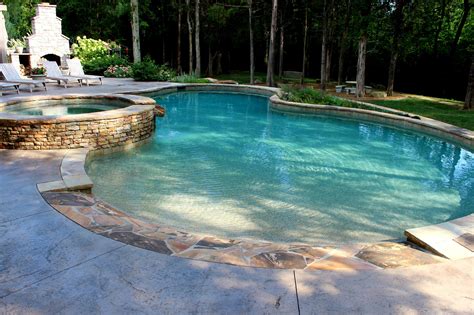 An Outdoor Swimming Pool Surrounded By Stone Steps