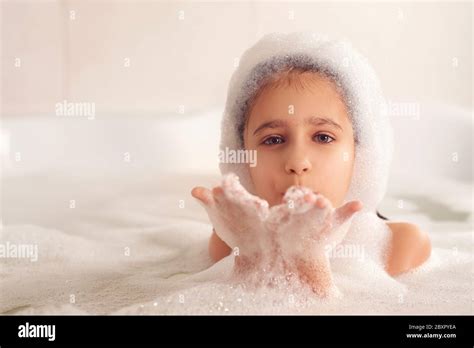 The Girl Bathes And Plays With Foam In The Bathroom It S A Big Drop Blowing Bubbles Stock