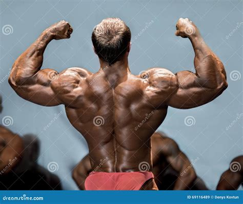 Back Double Biceps Pose By Brutal Caucasian Bodybuilder On Grunge Background Royalty Free Stock