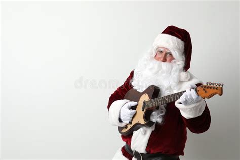Santa Claus Playing Electric Guitar On Light Background Space For Text