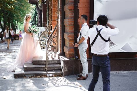 Premium Photo Wedding Photographer Takes Pictures Of Bride And Groom