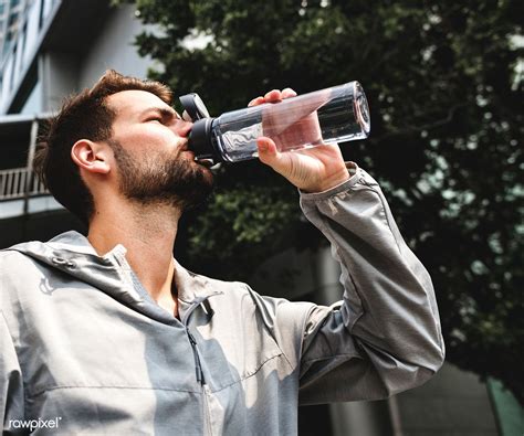 Download Premium Image Of Man Drinking Out Of A Water