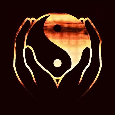 Two Hands Holding A Yin Yang Symbol In Front Of A Black Background With Orange Hues