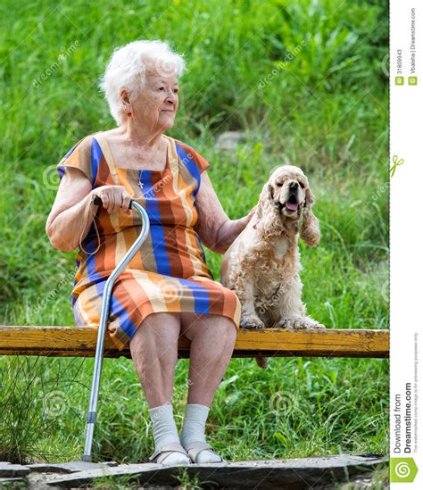 Old Woman And Her Dog Sitting On A Bench Stock Image Image Of Cane