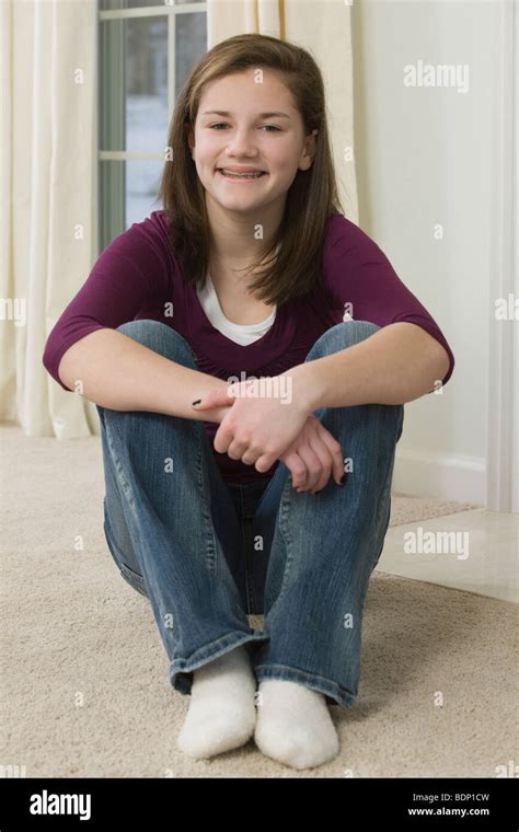 Teenage Girl Sitting On A Carpet Stock Photo Alamy