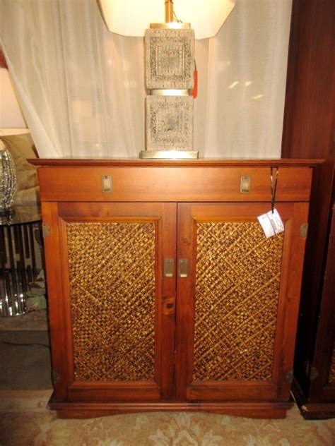 I love that you can display decor on the open shelves as well as hide office supplies and. Pier 1 Rattan Bar Cabinet at The Missing Piece