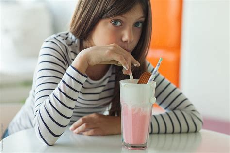 Girl Drinking Strawberry Milkshake By Stocksy Contributor Lumina