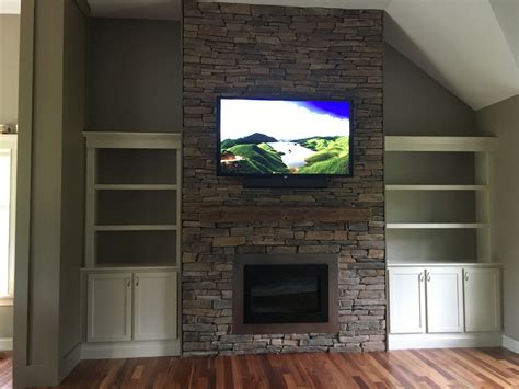 Flat Screen Tv Mounted On Natural Stone Fireplace With Cathedral