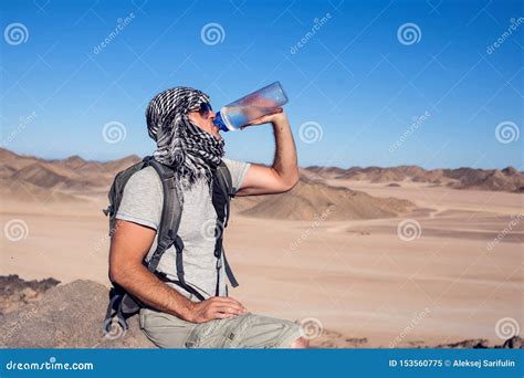 Man Feels Thirst And Drinks Water In The Desert Stock Image Image Of