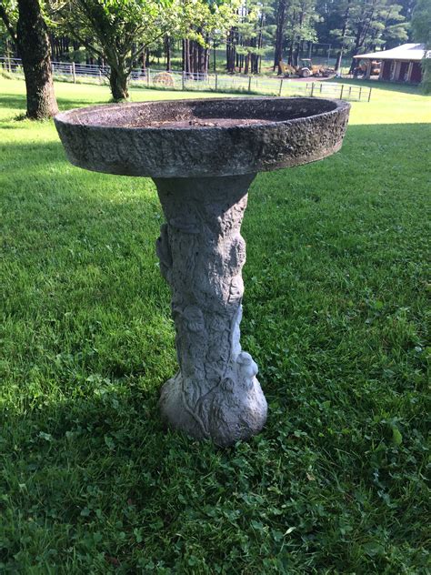 Vintage concrete bird bath...bird motif on base..26 inches tall..19.5