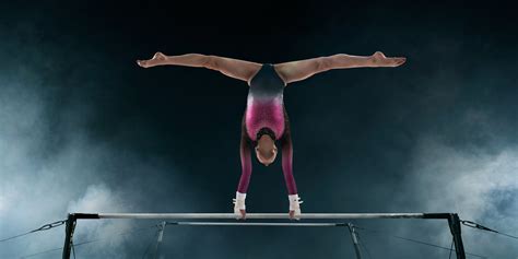 Femalegymnastdoingacomplicatedtrickongymnastichorizontalbar