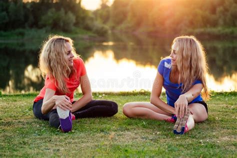 Two Lesbians Sisters Twins Beautiful Curly Blonde Young Woman In Stylish Dress Holding Hands In