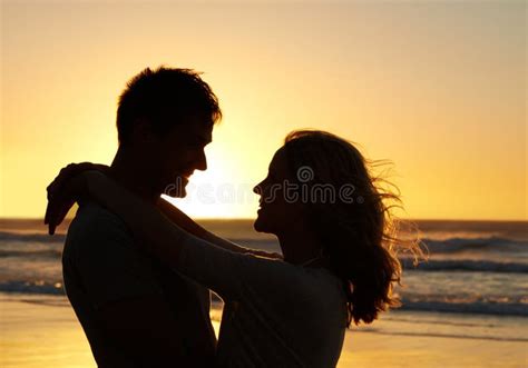 You Complete Me Romantic Shot Of A Couple Gazing Into Each Others Eyes On The Beach At Sunset