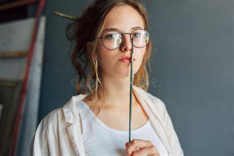 Portrait Of A Beautiful Female Artist In Eyeglasses Posing In Her