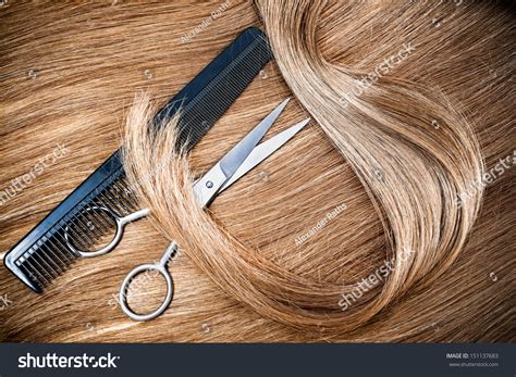 Professional Hairdresser Scissors And Comb On Hair Background Stock