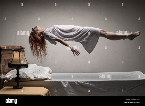 Woman Levitating Over Bed Astral Traveling Nightmare Excorcist Halloween Concept Stock Photo