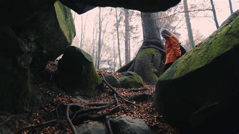 Beautiful Shot From Below Girl Walking In The Rocky Autumn Forest Look