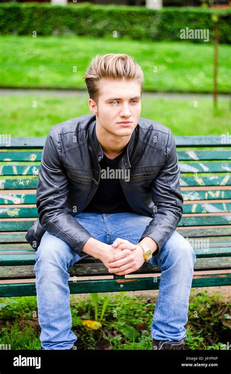 Handsome Blond Young Man Sitting On Park Bench Stock Photo Alamy